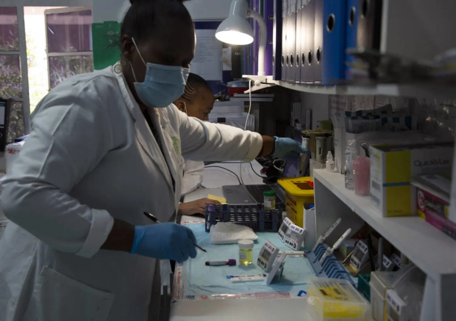 Laboratory technicians test a blood sample for HIV infection at the Reproductive Health and HIV Institute (RHI) in Johannesburg, Thursday, Nov. 26 2020. The successful trials of a new injectable drug that needs to be taken every eight weeks to prevent HIV infection is being lauded on World AIDS Day as a turning point for the fight against a global health threat that's been eclipsed by the coronavirus pandemic. (AP Photo/Denis Farrell)
