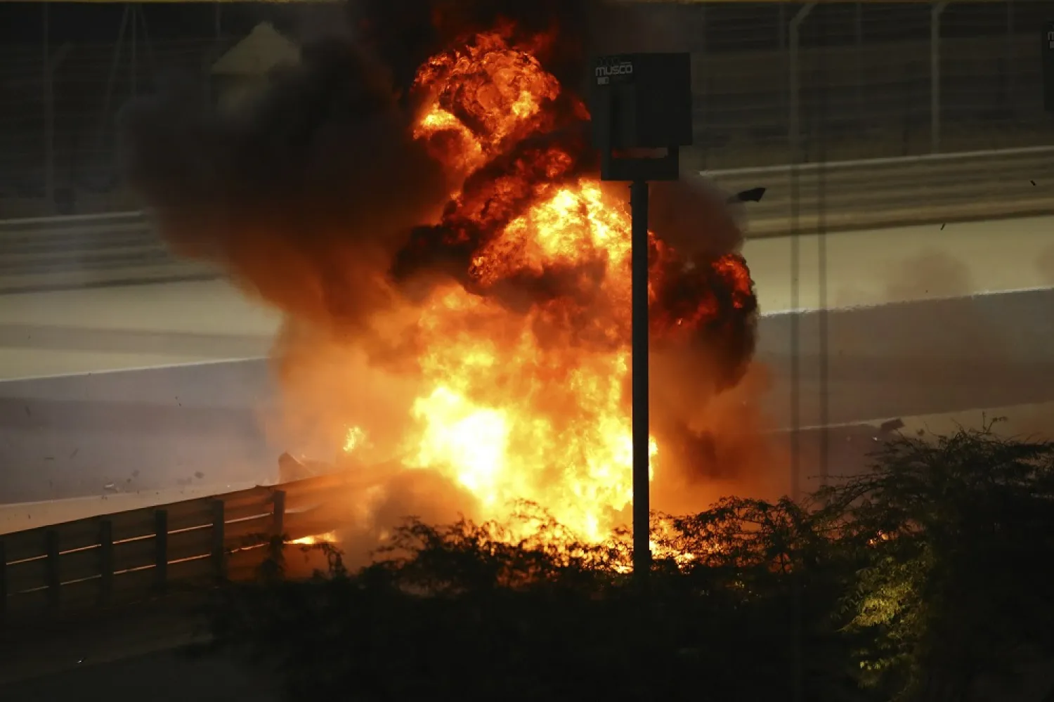 Flames seen from the crash scene after Romain Grosjean crashed out at the start of the race during the F1 race in Bahrain International Circuit in Sakhir, Bahrain, Nov. 29, 2020. (AP)