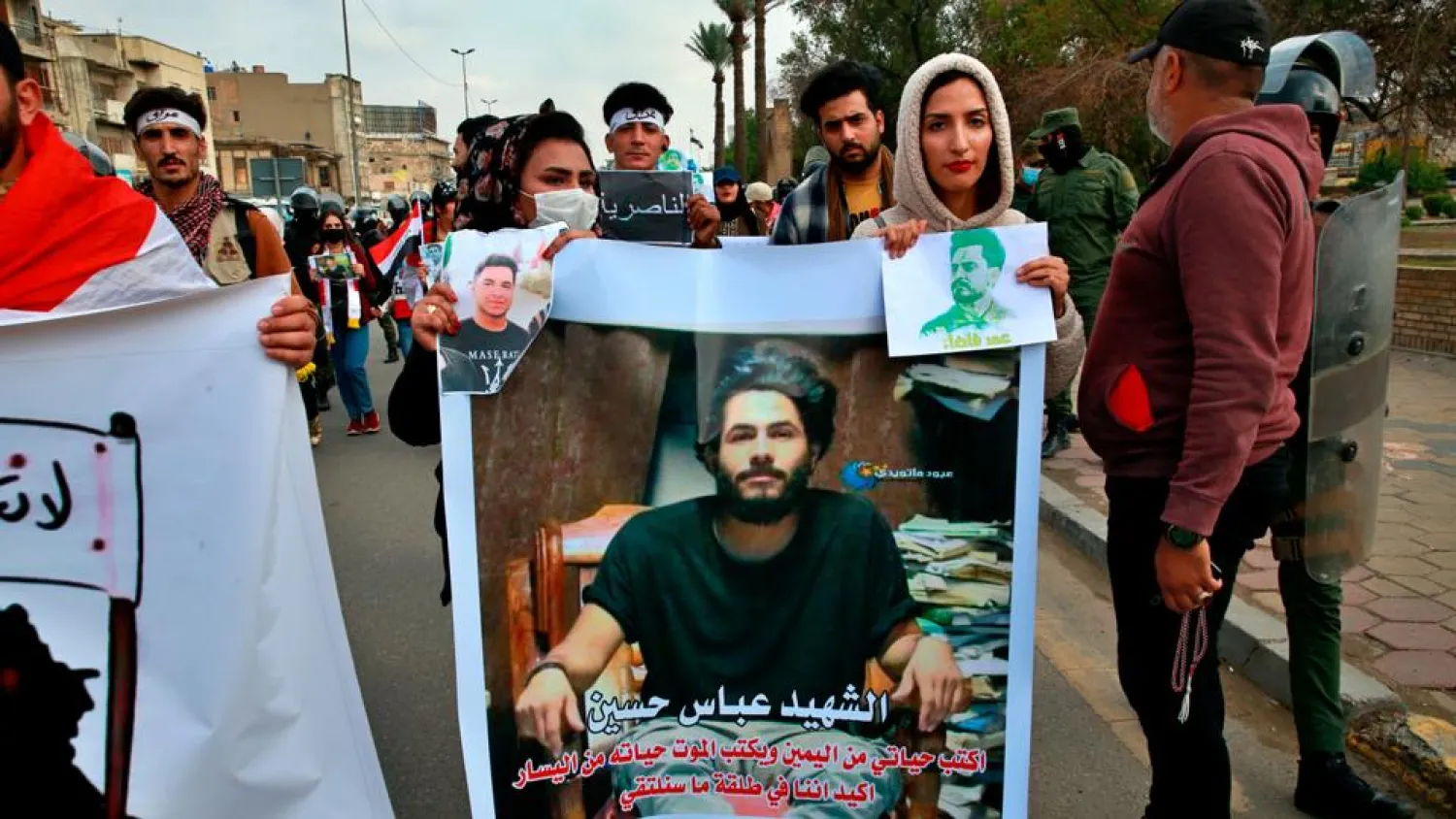 Protesters hold pictures of people who have been killed in anti-government protests during a demonstration calling for the government to resign, in Baghdad, Iraq, on November 29, 2020. (AP)