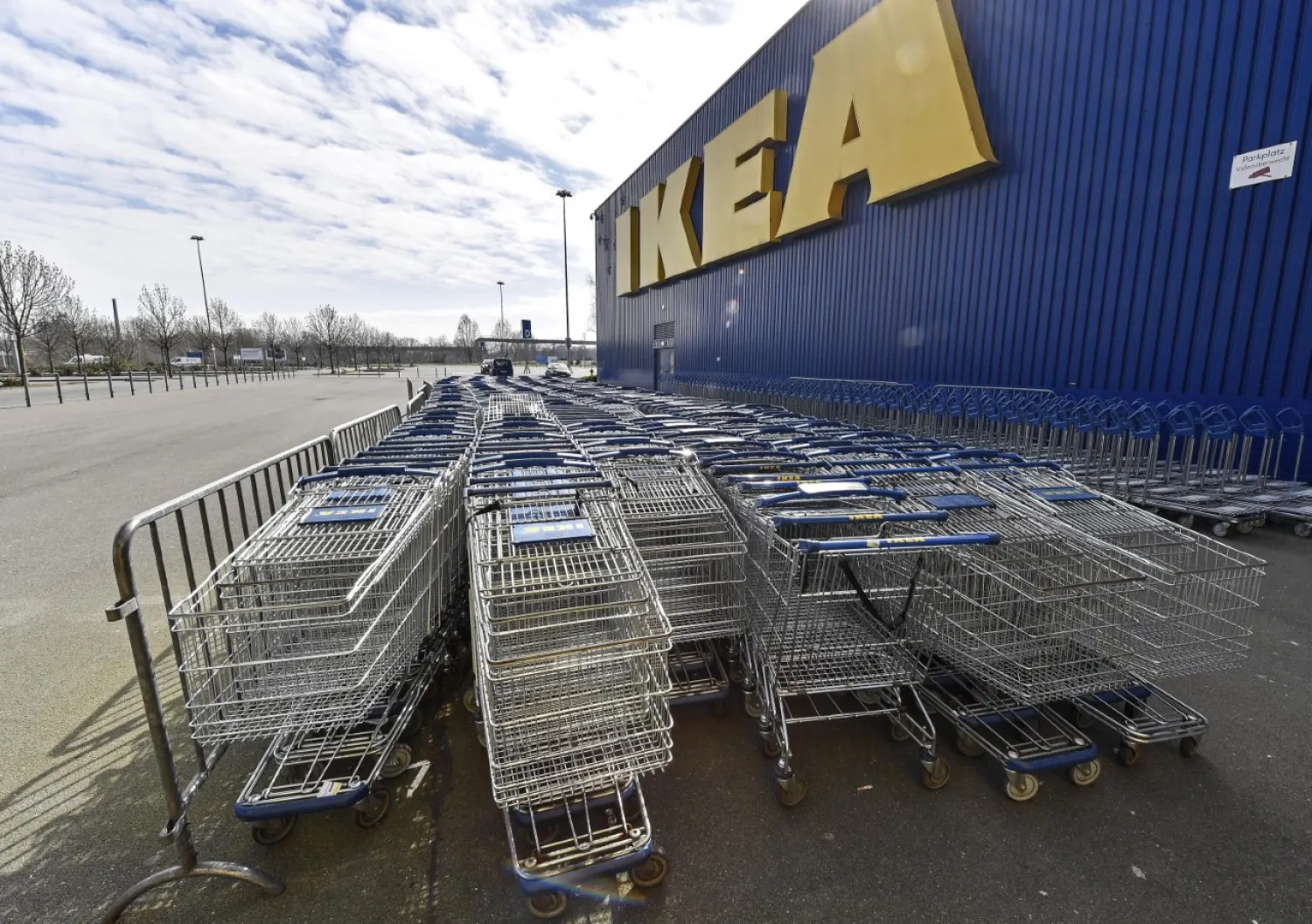 Empty trolleys are stored in front of an IKEA store in Duisburg, Germany, March 19, 2020. (AP Photo)