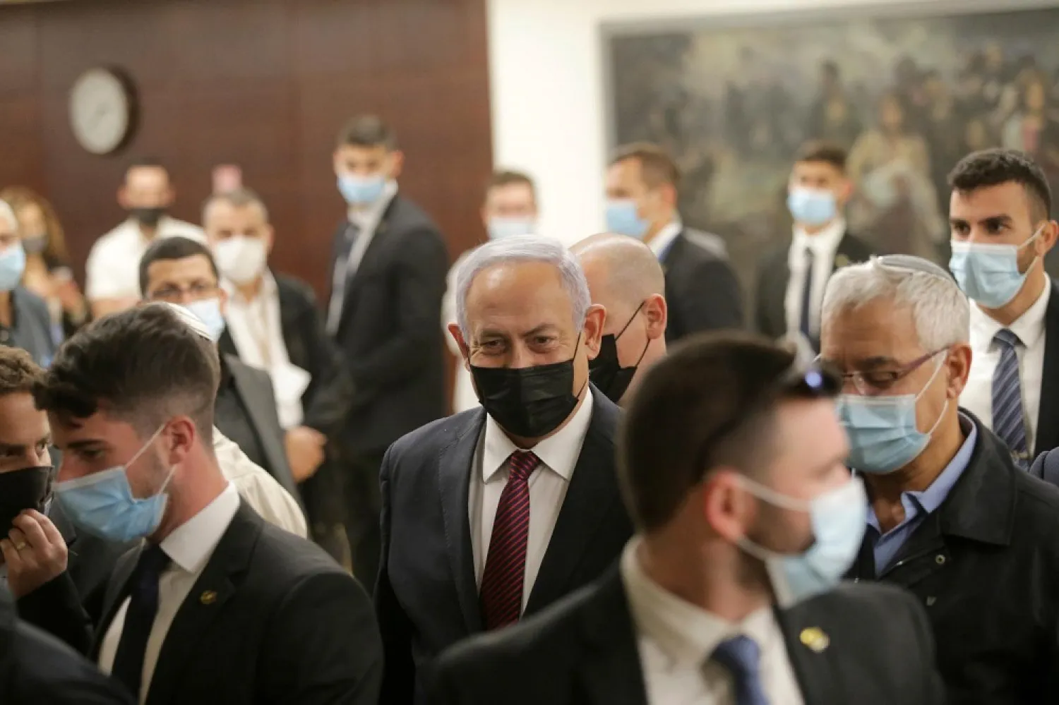 Israeli Prime Minister Benjamin Netanyahu, center, leaves the Israeli Knesset (parliament) after a vote on the dissolution of the Knesset, in Jerusalem, Wednesday, Dec. 2 2020. (AP)