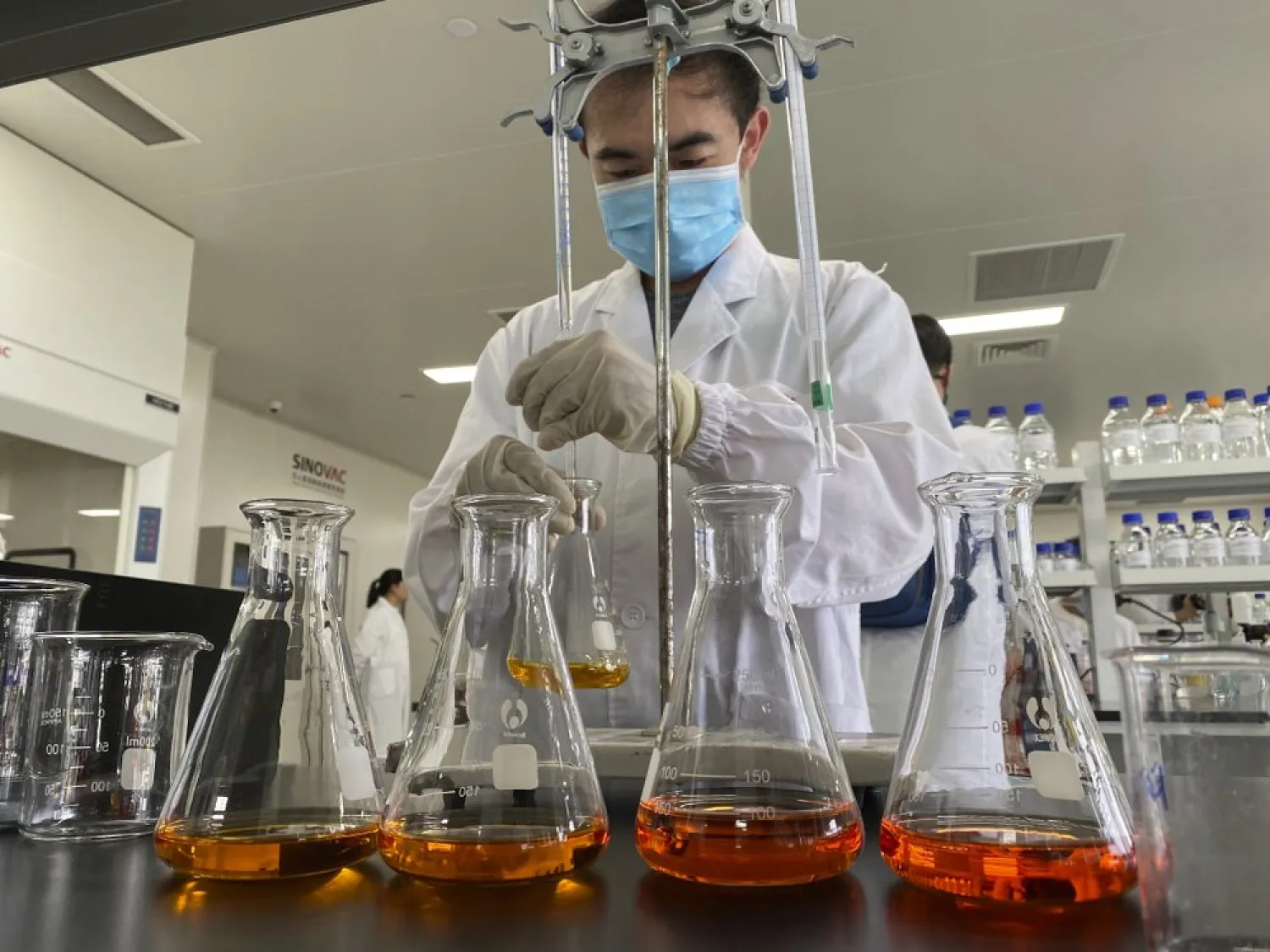 A worker works inside a lab at the SinoVac vaccine factory in Beijing on Thursday, Sept. 24, 2020. SinoVac, one of China's pharmaceutical companies behind a leading COVID-19 vaccine candidate says its vaccine will be ready by early 2021 for distribution worldwide, including the US (AP Photo/Ng Han Guan)
