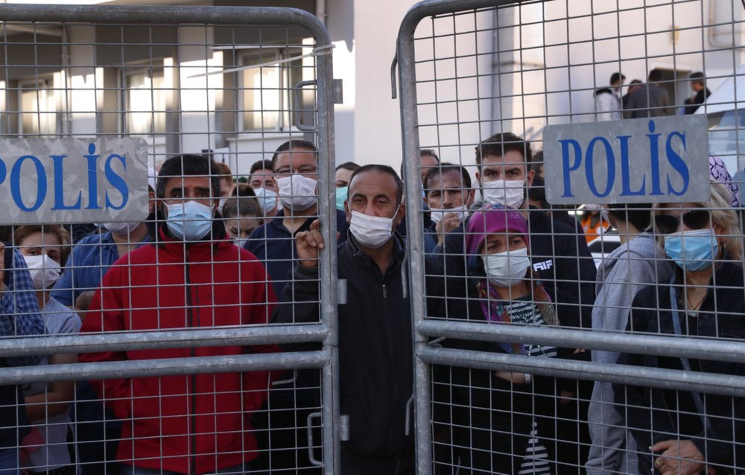 FILE: Local residents watch as medics and rescue personnel carry into an ambulance an injured person from the debris of a collapsed building after an earthquake in Izmir, Turkey, Saturday, Oct. 31, 2020.  (AP Photo/Darko Bandic)
