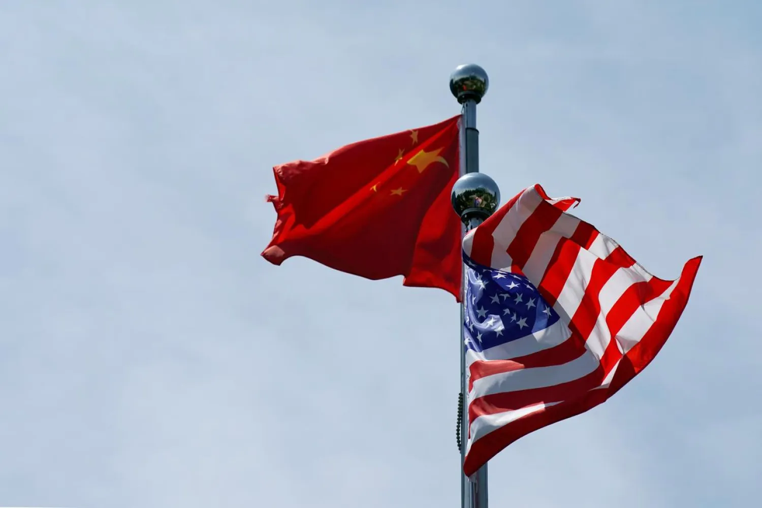 FILE PHOTO: Chinese and US flags flutter in Shanghai, China July 30, 2019. REUTERS/Aly Song/File Photo/File Photo