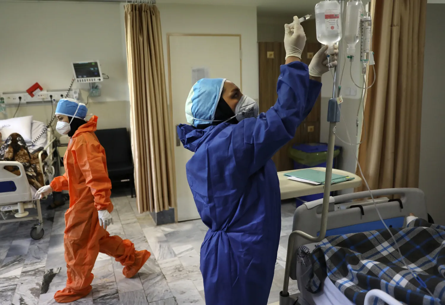 Nurses tend to COVID-19 patients at the Shohadaye Tajrish Hospital in Tehran, Iran, June 16, 2020. (AP Photo/Vahid Salemi)