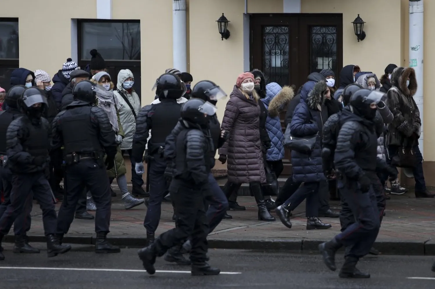 Riot police block Belarusian pensioners wearing face masks to protect against coronavirus during an opposition rally to protest the official presidential election results in Minsk, Belarus, Monday, Nov. 30, 2020. (AP Photo)
