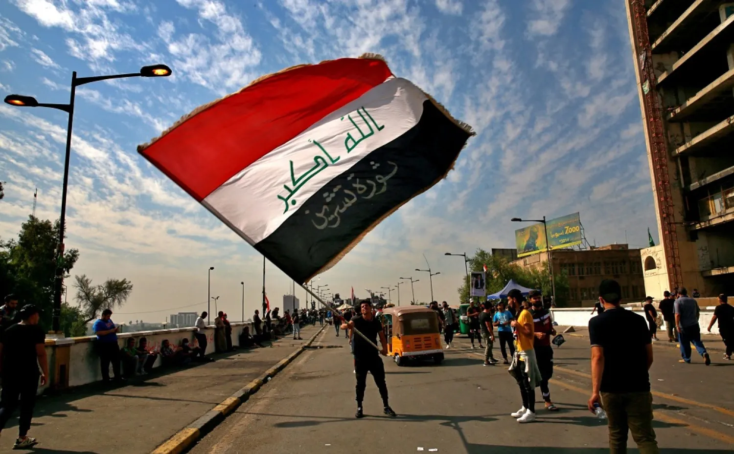 Anti-government protesters gather on the closed Joumhouriya Bridge that leads to the Green Zone government areas in Baghdad, Iraq, Oct. 25, 2020. (AP)