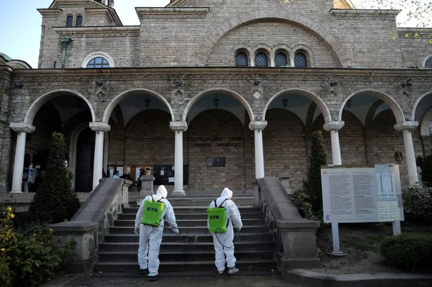 Workers spray disinfectant against the coronavirus outbreak outside St Nedelya church ahead of Orthodox Palm Sunday services in Sofia, Bulgaria, April 11, 2020. REUTERS/Stoyan Nenov