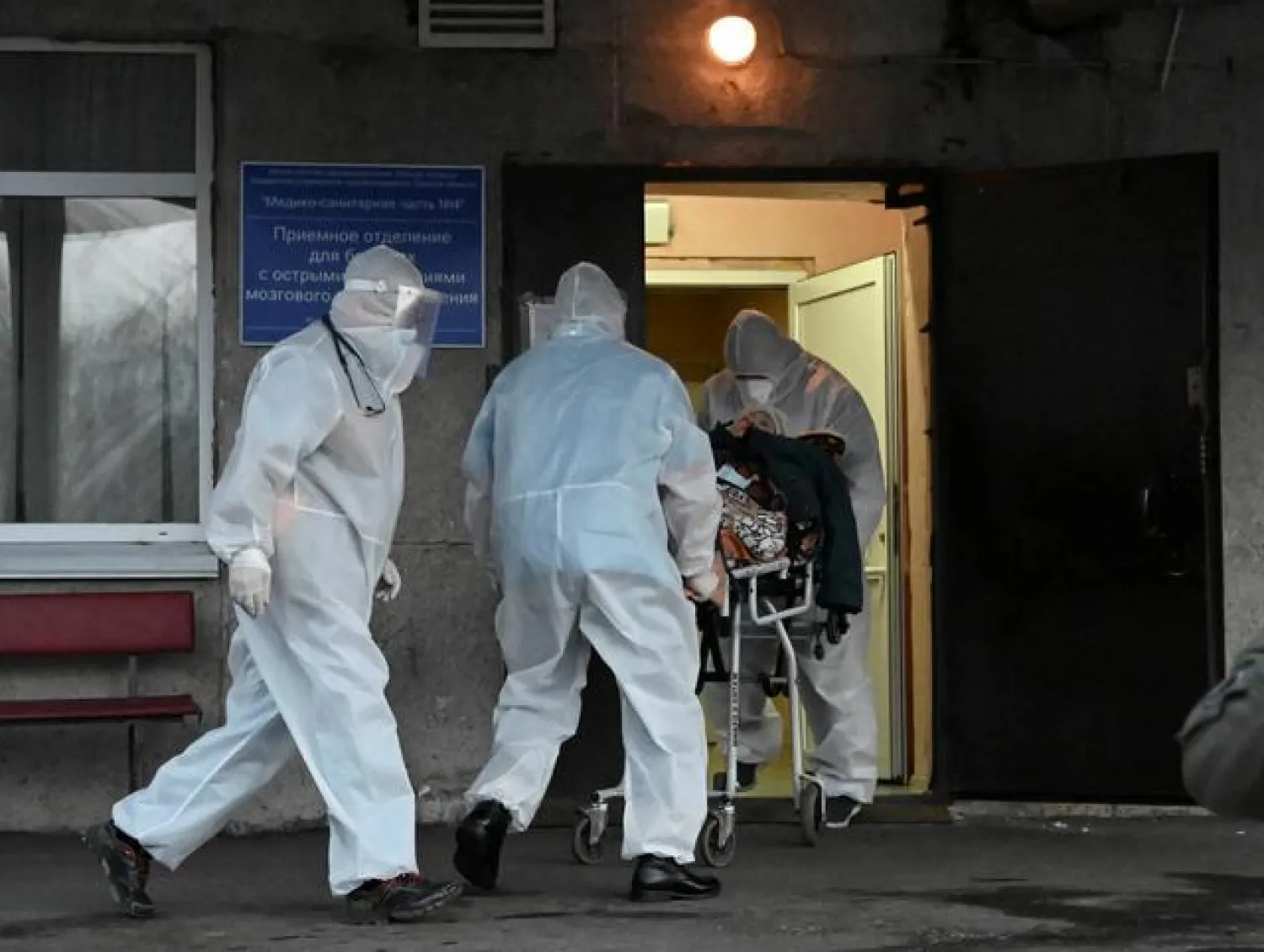 
FILE PHOTO: Paramedics wearing personal protective equipment (PPE) push a stretcher while transporting a patient to a hospital amid the coronavirus disease (COVID-19) outbreak in Omsk, Russia October 28, 2020. REUTERS/Alexey Malgavko