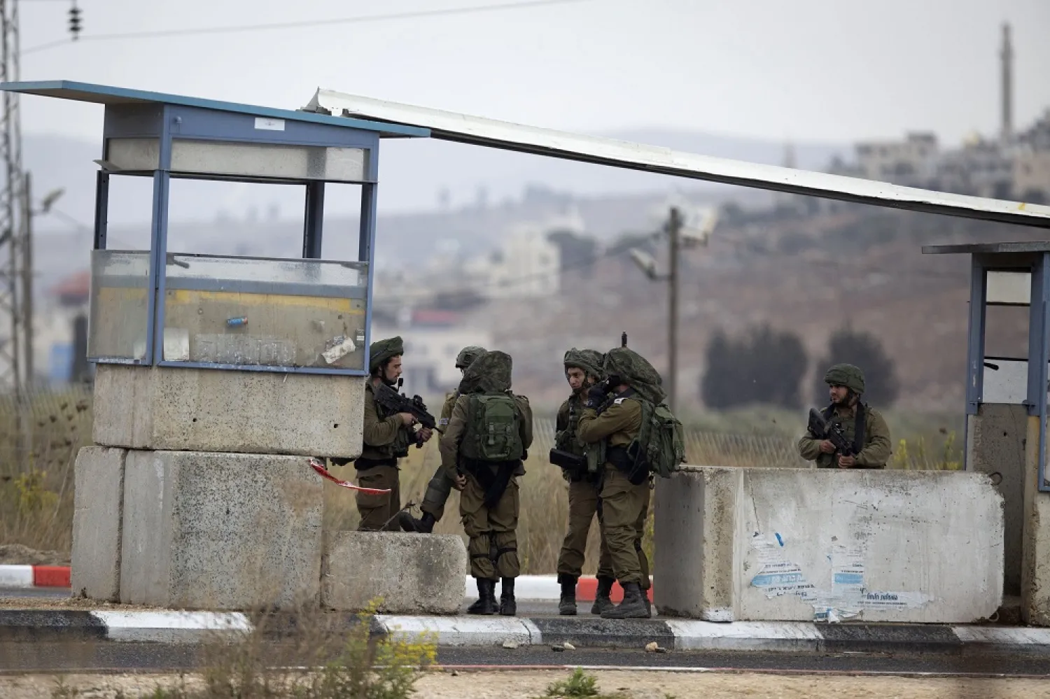 Israeli soldiers secure the area at the Huwara checkpoint south of the West Bank city of Nablus, Nov. 4, 2020. (AP)