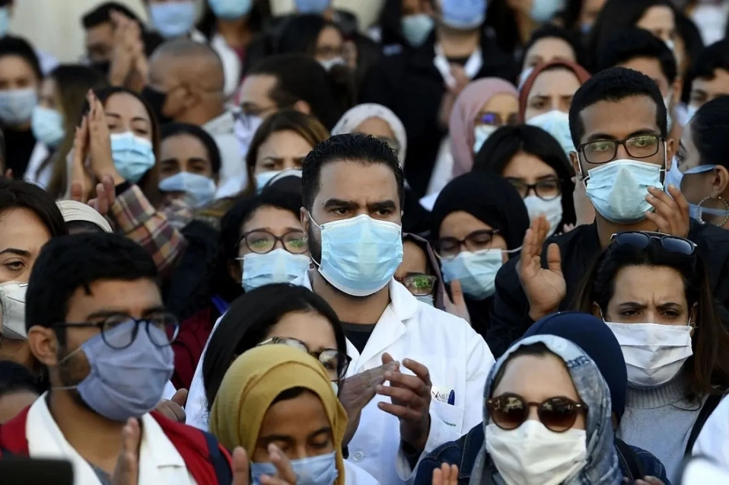 Tunisian doctors and medical students protest on December 4, 2020 in front of the headquarters of the health ministry after the death of a resident doctor, who fell from a broken hospital elevator. (AFP)