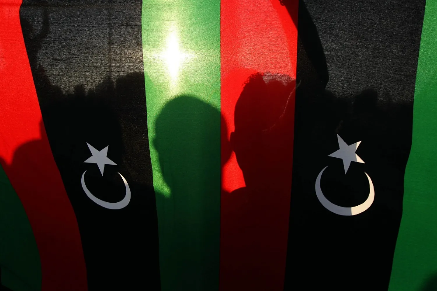 Libyan protesters are seen behind the national flag during a rally on May 23, 2014 in Benghazi, eastern Libya. (Getty Images)