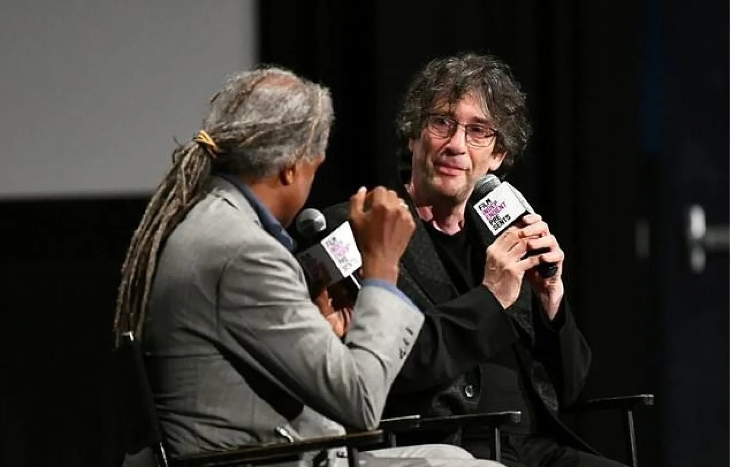 Fantasy author Gaiman, right, asked his Twitter followers to share their experiences of being warm to help inspire his poem - AFP