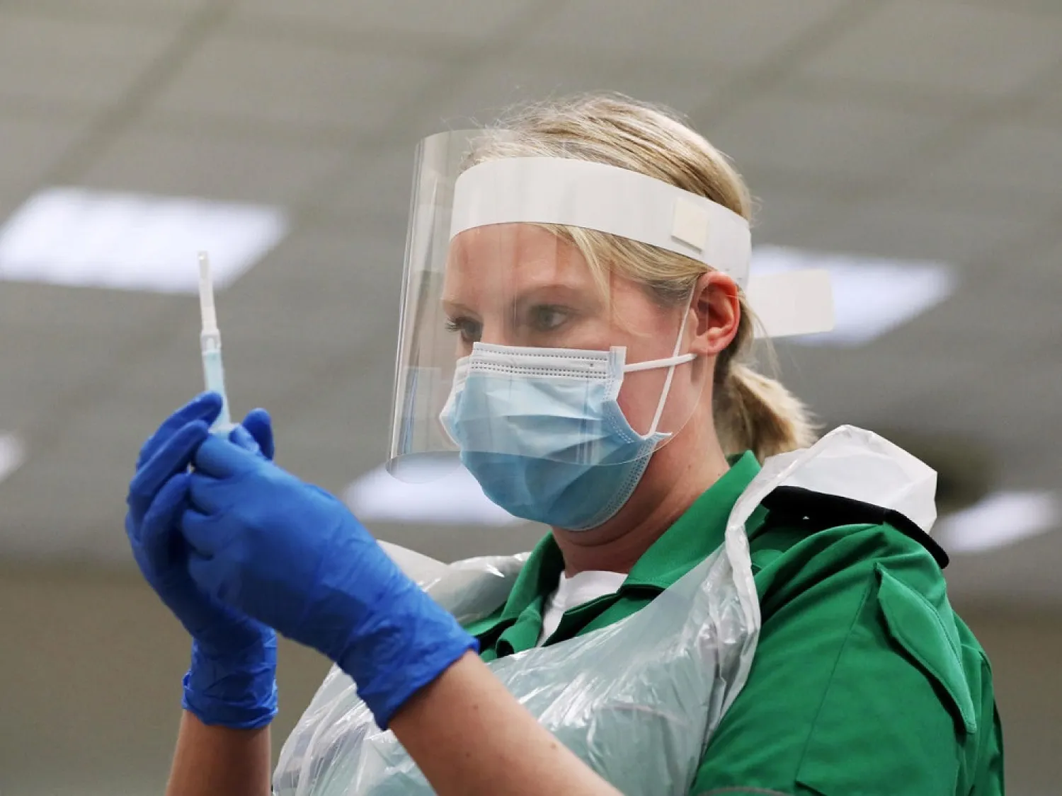 A St. John's Ambulance volunteer holds a syringe during a coronavirus vaccinator training course at the Princess Anne Training Centre in Derby, Britain on November 28, 2020. (Reuters)