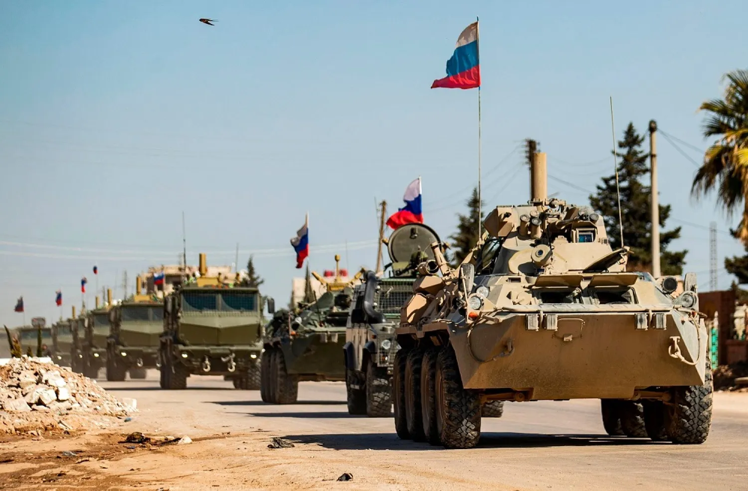 Russian military vehicles driving in a convoy from the town of Tal Tamr to Qamishli airport, March 9, 2020. (AFP)