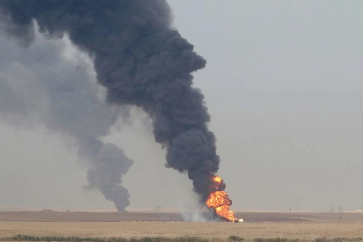 Smoke rises from oil wells inside the Khabbaz oilfield after they were bombed on the outskirts of Kirkuk, Iraq December 9, 2020. (Reuters)