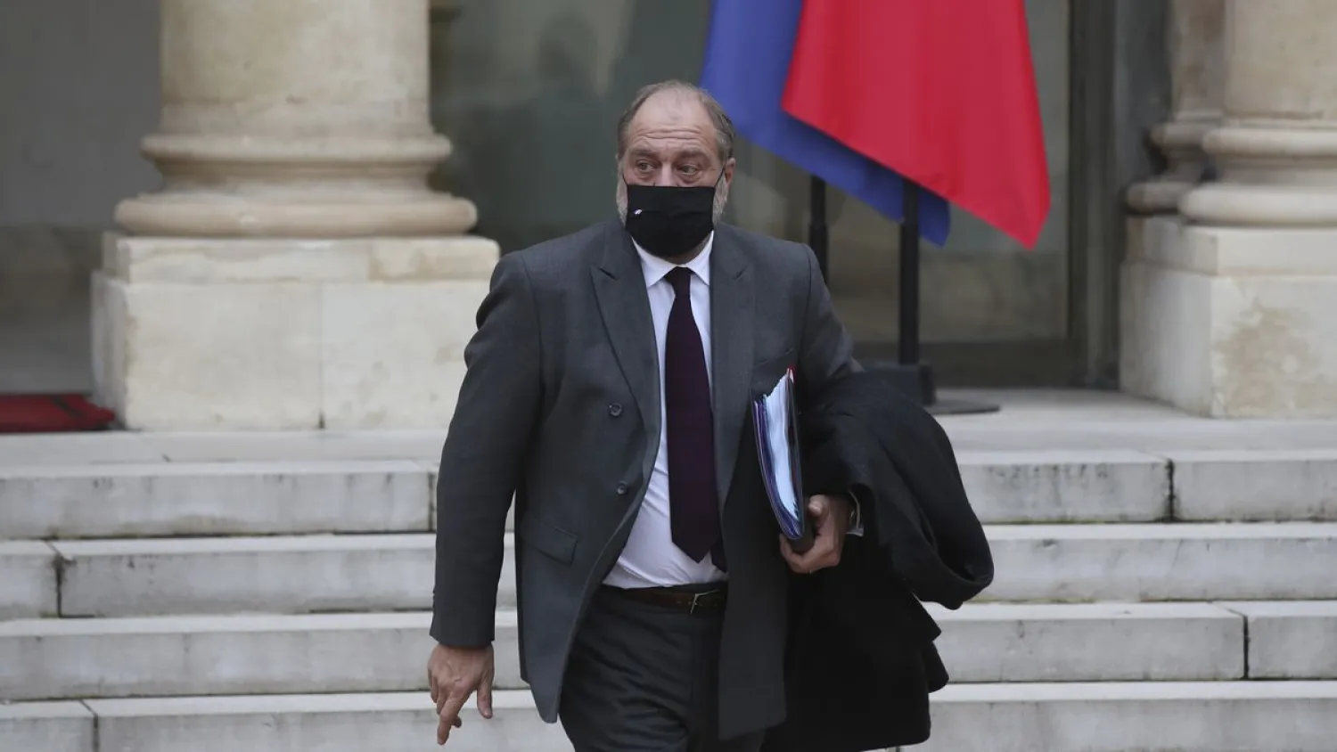 French Justice Minister Eric Dupond-Moretti leaves the weekly Cabinet meeting at the Elysee Palace in Paris, Wednesday, Des. 9, 2020. A draft law aimed at arming France against Islamist radicalism was unveiled at Wednesday's weekly Cabinet meeting, a measure promoted by President Emmanuel Macron to rout out what he calls "separatists" undermining the nation. (AP Photo/Michel Euler)