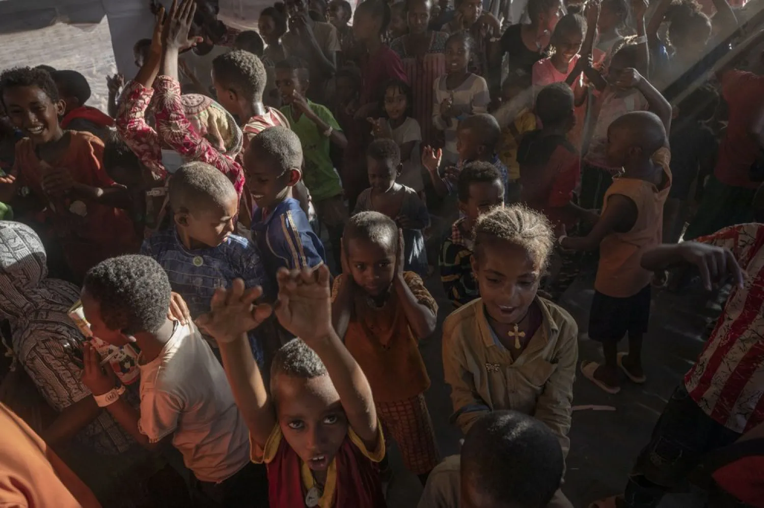 Tigray refugee children sing and dance inside a tent run by UNICEF for children's activities, in Umm Rakouba refugee camp in Qadarif, eastern Sudan, Thursday, Dec. 10, 2020. (AP Photo/Nariman El-Mofty)
