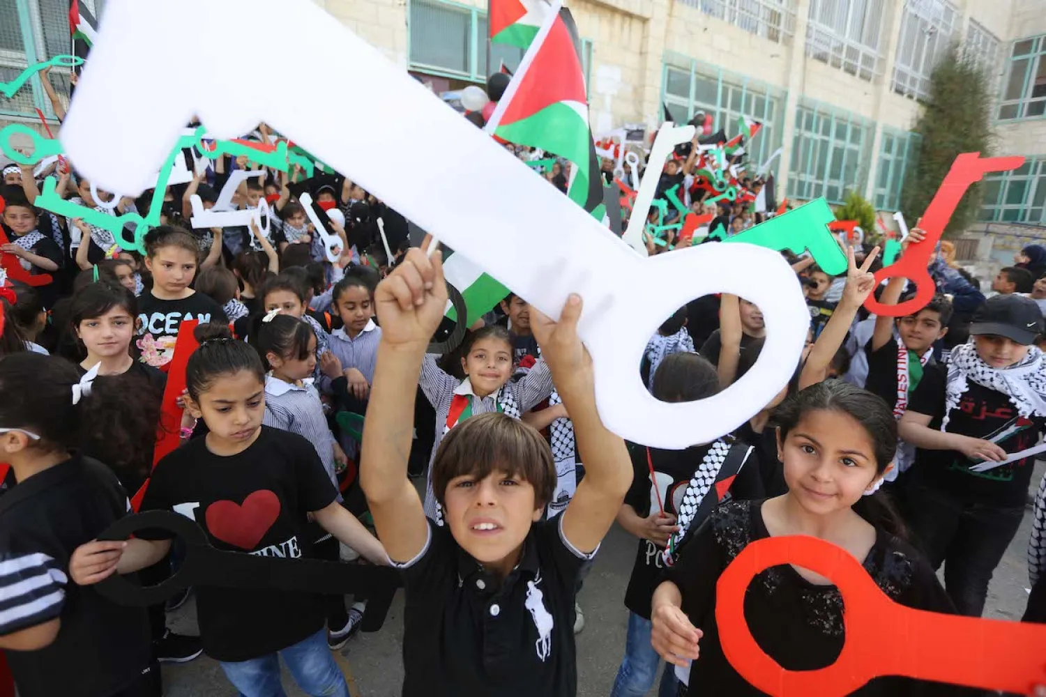 Palestinian children hold model keys symbolizing the houses which Palestinians left as part of the Nakba, during a demonstration marking the 69th anniversary of Nakba, also known as Day of the Catastrophe in 1948, in Ramallah, West Bank on 15 May 2017. Issam Rimawi – Anadolu Agency