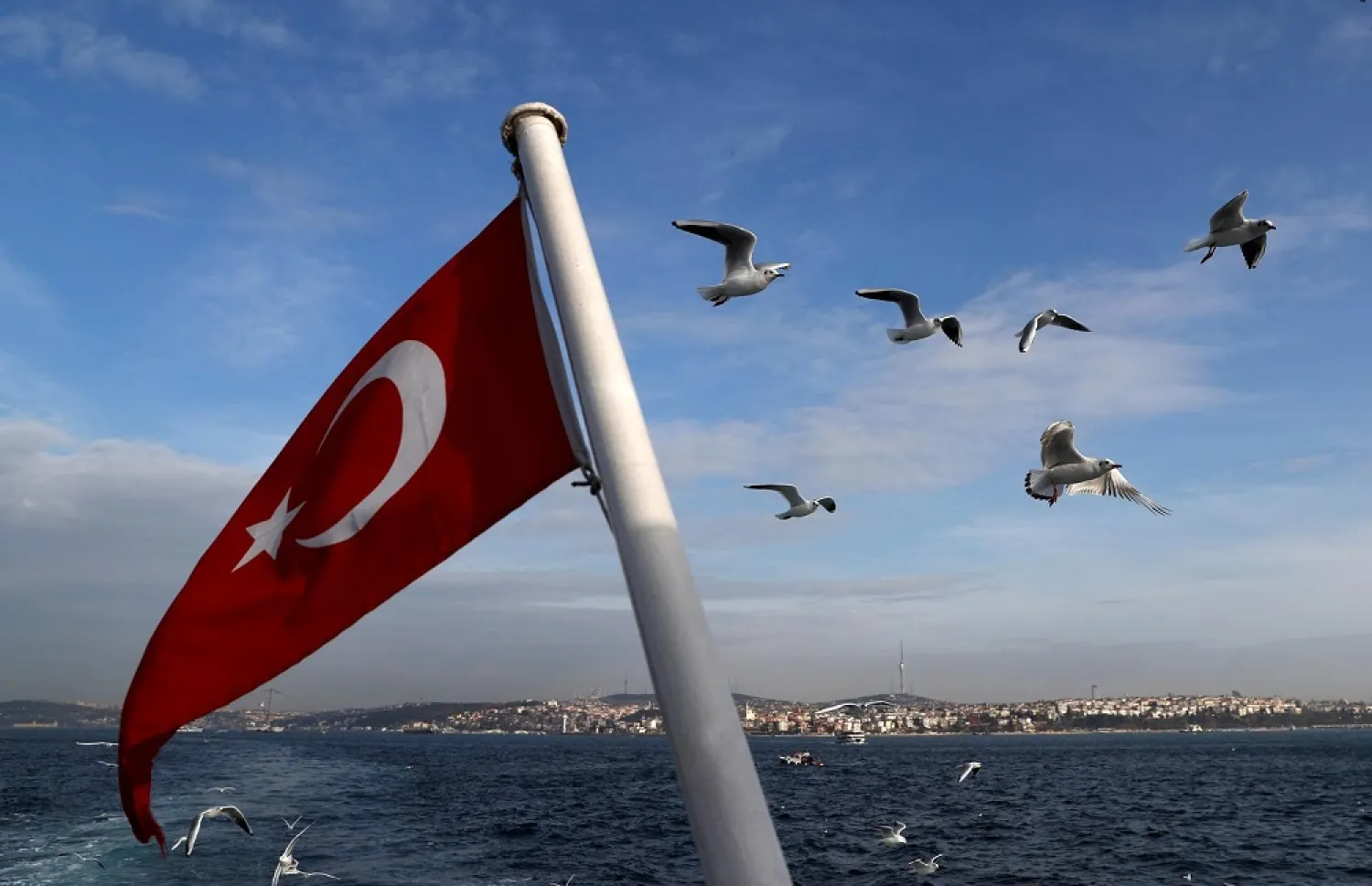 A Turkish flag flies on a passenger ferry with the Bosphorus in the background in Istanbul, Turkey, January 27, 2020. (Reuters)