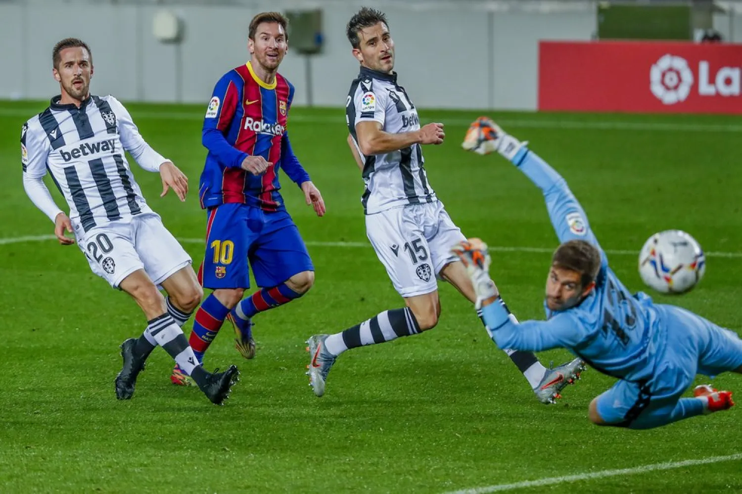 Barcelona's Lionel Messi scores his side's first goal during the Spanish La Liga match between FC Barcelona and Levante at the Camp Nou stadium in Barcelona, Spain, Dec. 13, 2020. (AP)
