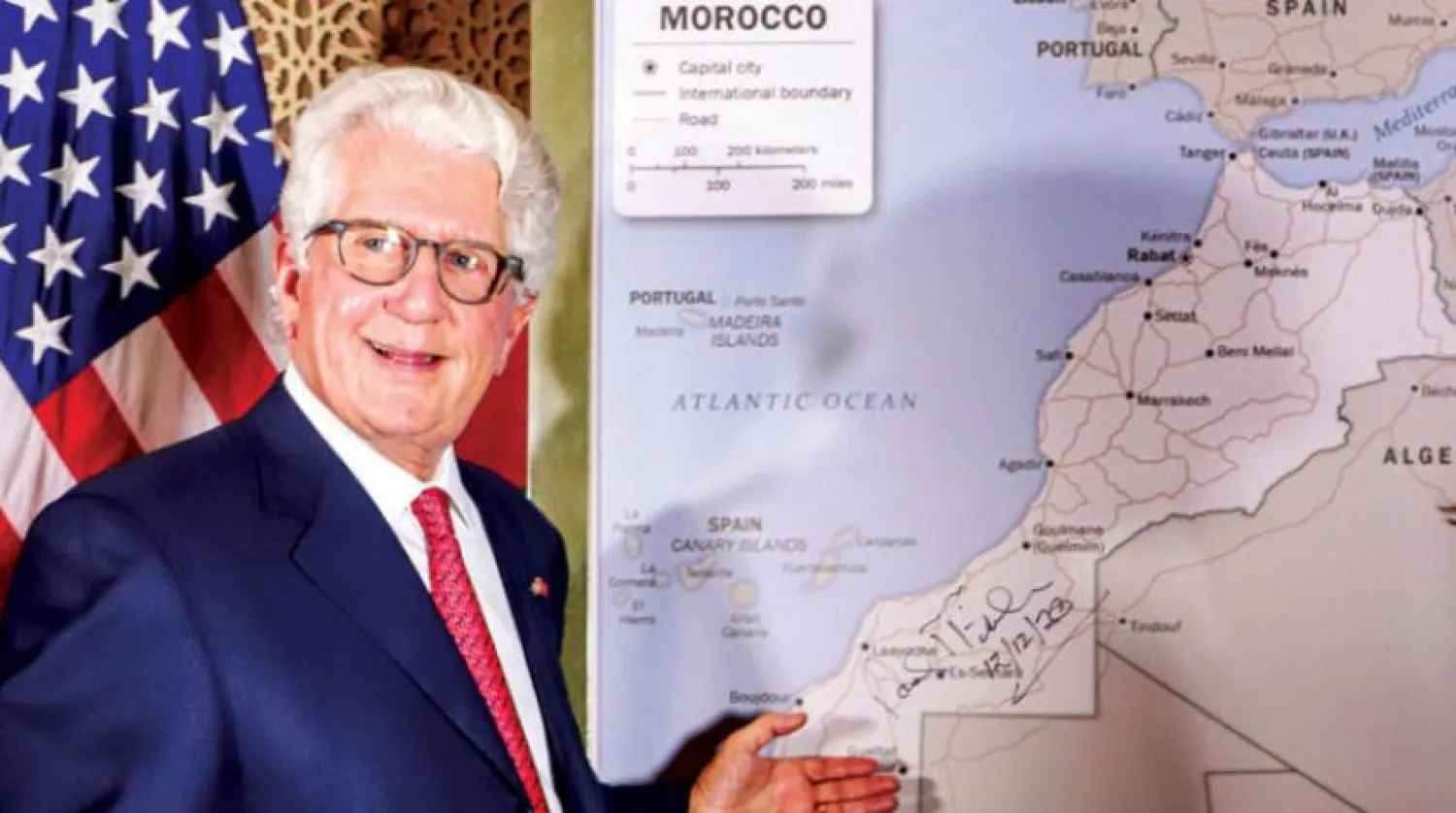 David Fischer, US ambassador to Rabat, stands in front of a US State Department-authorized map of Morocco recognizing the internationally disputed territory Western Sahara as a part of the North African kingdom on Dec. 12, 2020. (AFP) 