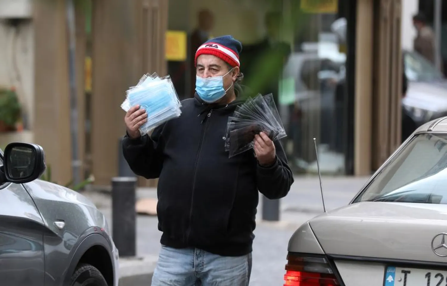 A street vendor sells face maks used to prevent the spread of the coronavirus disease, along a street in Beirut, Lebanon on December 15, 2020 | REUTERS