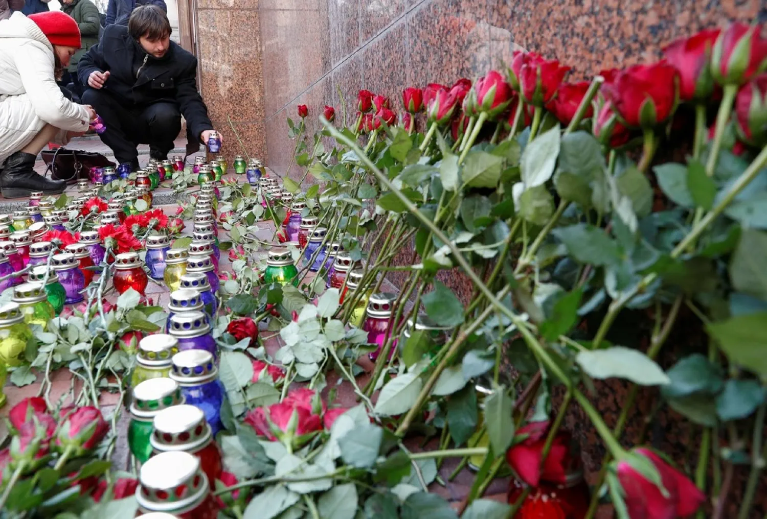 People place candles as they commemorate victims of the Ukraine International Airlines flight 752 plane disaster, in front of the Iranian embassy in Kiev, Ukraine February 17, 2020. (Reuters)