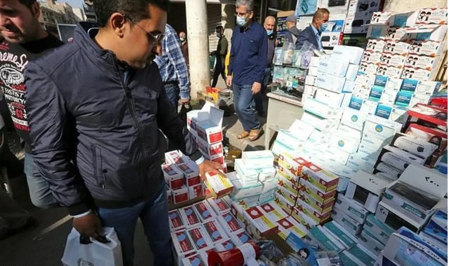 Cartons of surgical masks, transparent face shields and disinfectant bottles have piled up despite being on sale at slashed prices - AFP