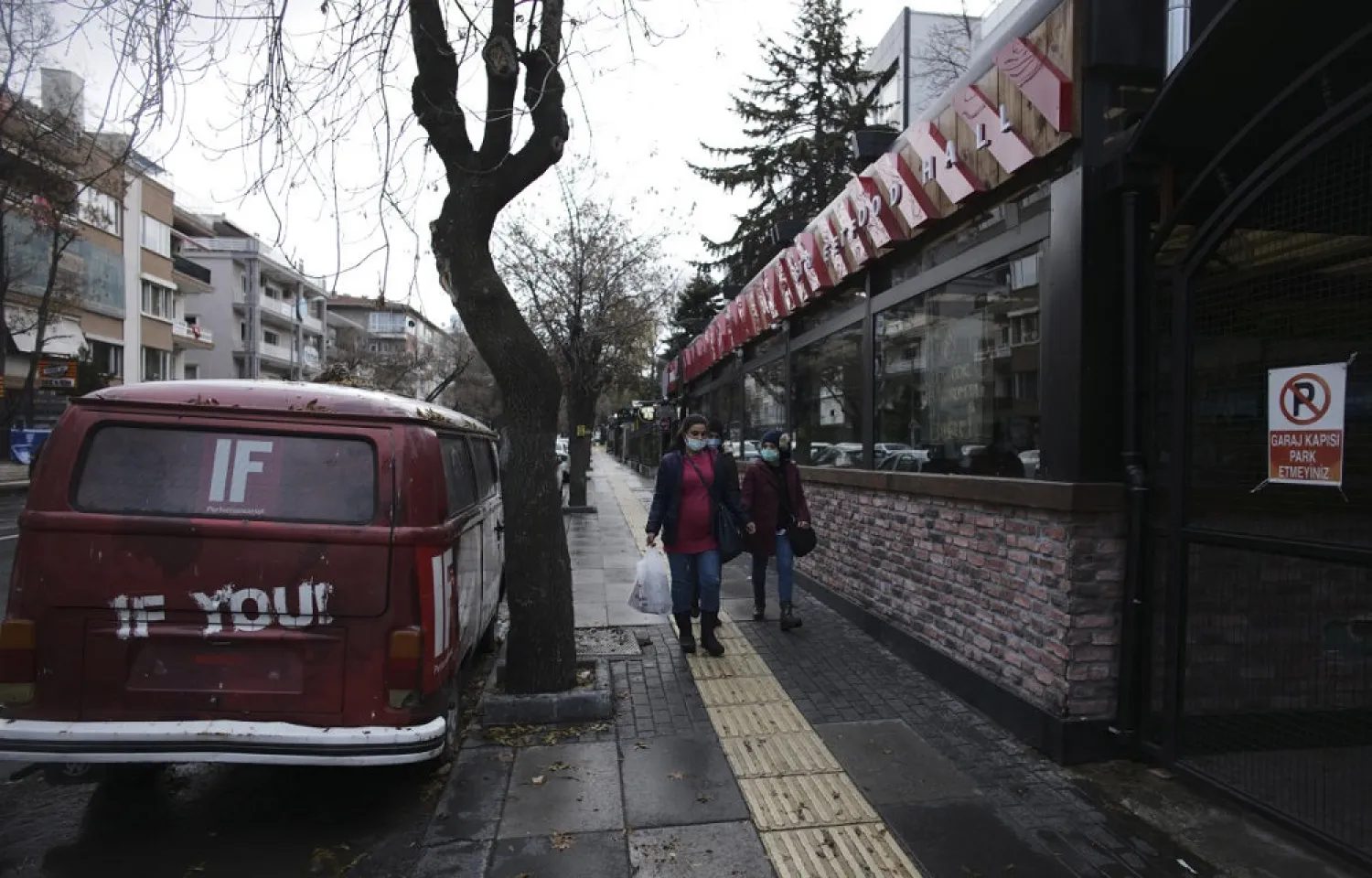 People wearing masks to help protect against the spread of coronavirus, walk during a two-day weekend curfew, in Ankara, Turkey, Dec. 13, 2020. (AP)