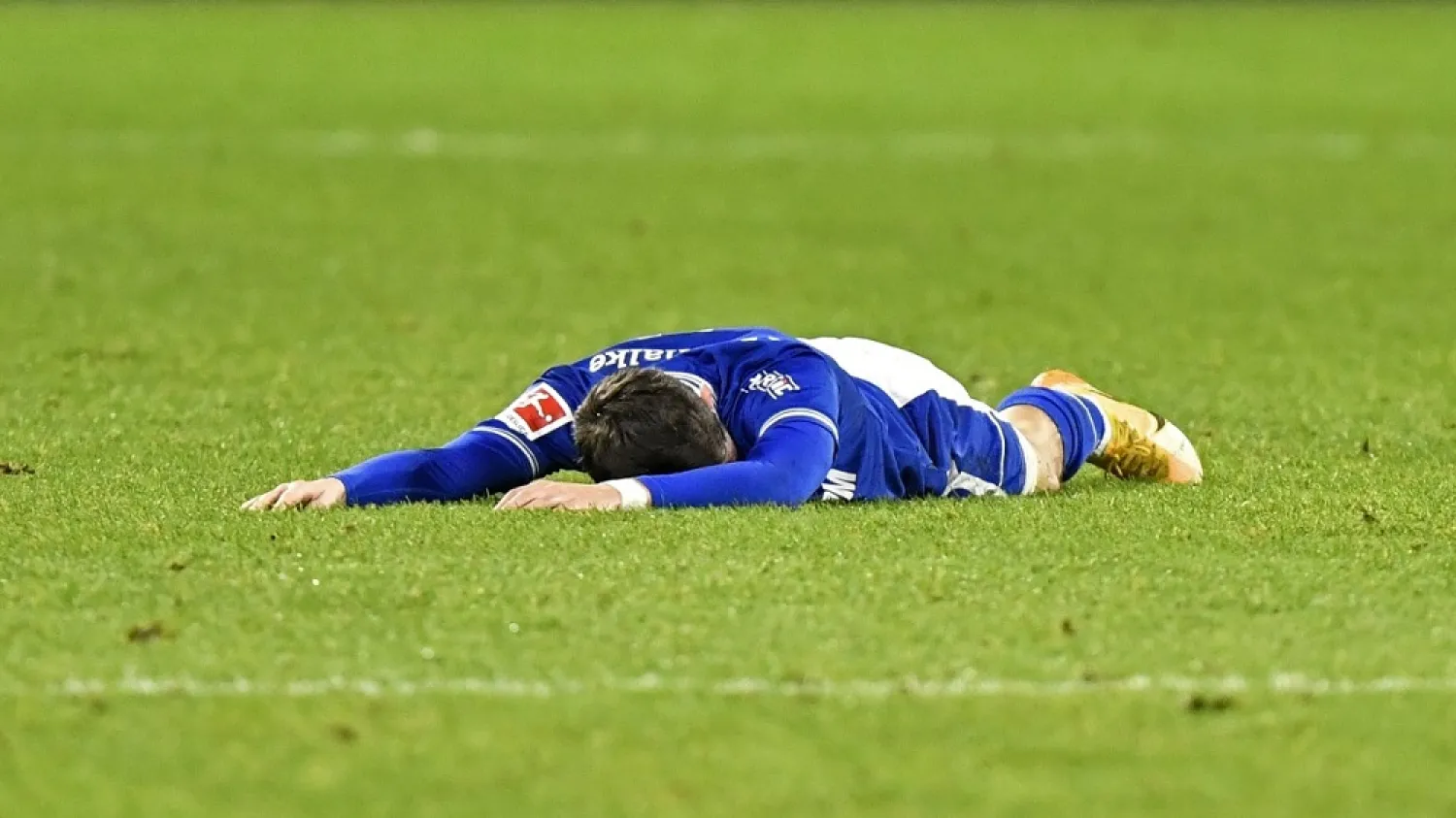 Schalke’s Benito Raman lies on the ground during the Bundesliga match between FC Schalke 04 and SC Freiburg at the Arena in Gelsenkirchen, Germany, Dec. 16, 2020. (AP)