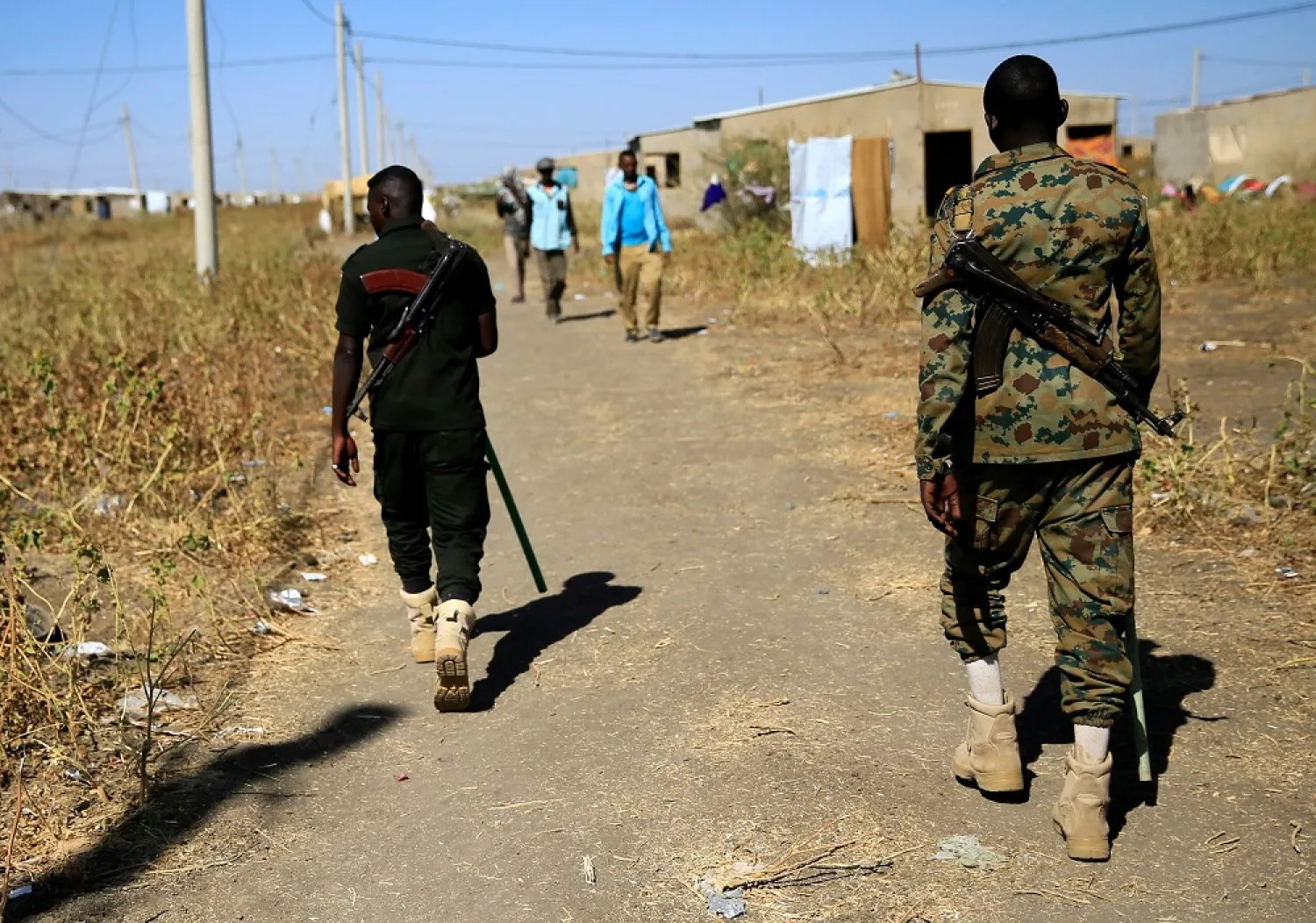 Sudanese security officers patrol as Ethiopian refugees, who fled the Tigray region, are seen at the Fashaga camp on the Sudan-Ethiopia border, in Kassala state, Sudan, Dec. 13, 2020. (Reuters)