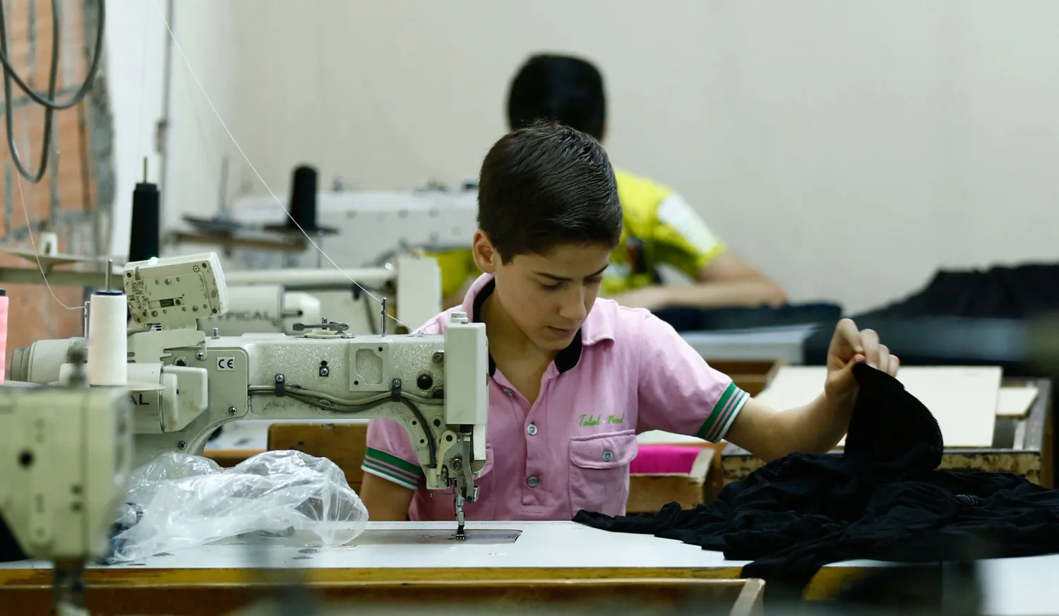 A 13-year-old from Syria, works in his father's basement factory in Istanbul. REUTERS/Murad Sezer