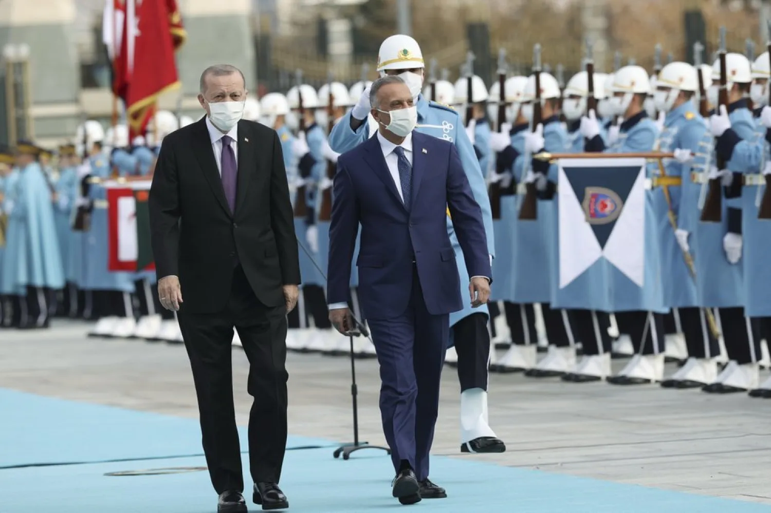 Turkey's President Erdogan, left, walks with Iraqi PM Kadhimi, center, as they review an honor guard at the Presidential Palace in Ankara, Turkey, Thursday, Dec. 17, 2020. (AP)