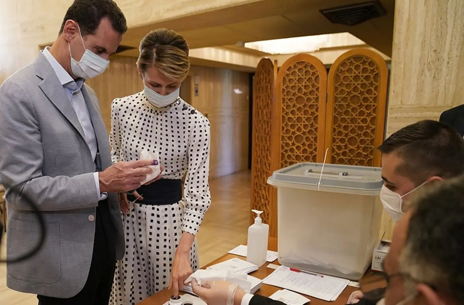Bashar Assad and his wife Asma at a polling station in Damascus on July 19. (AFP)