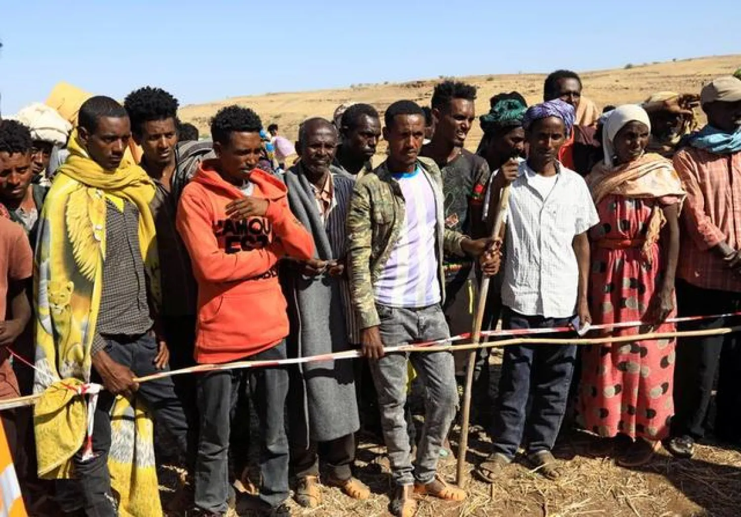 Ethiopians who fled the ongoing fighting in Tigray region gather to receive relief aid at the Um-Rakoba camp on the Sudan-Ethiopia border, in Kassala state, Sudan December 17, 2020. Picture taken December 17, 2020. REUTERS/Mohamed Nureldin Abdallah