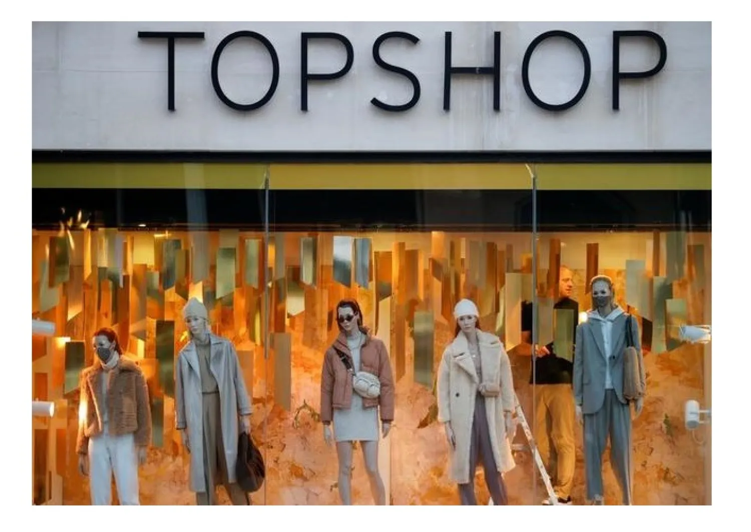 FILE PHOTO: A man stands in the window of the Topshop store, amid the outbreak of the coronavirus disease (COVID-19), in Liverpool, Britain December 1, 2020. REUTERS/Phil Noble