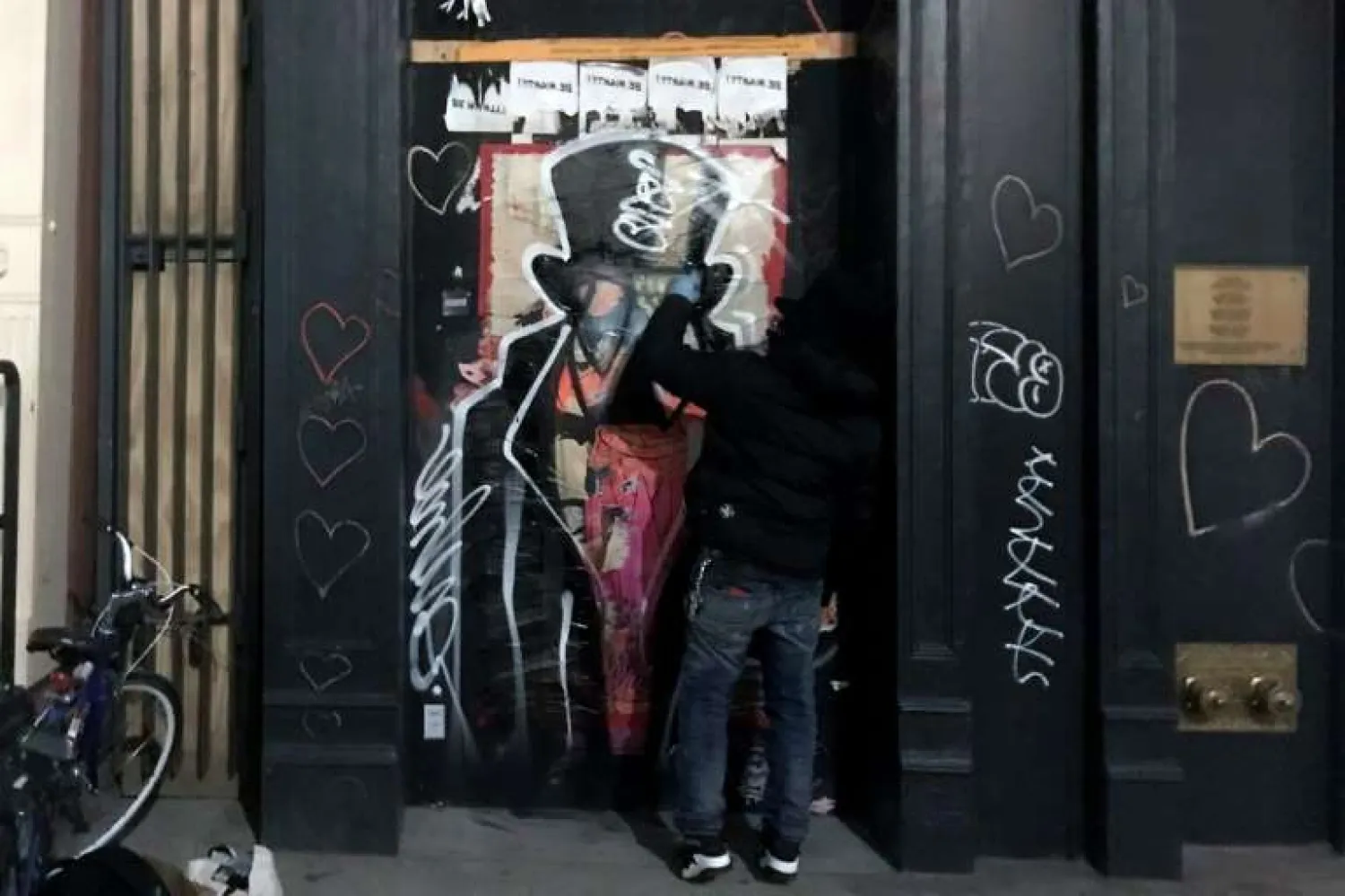 Graffiti artist Saynosleep painting on a storefront in New York in December 2020 | AFP