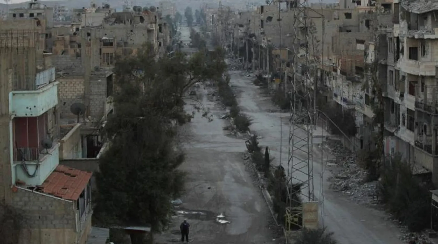 A man walks along a deserted street filled with debris in Deir Ezzor, eastern Syria February 14, 2014. REUTERS/Khalil Ashawi/File Photo