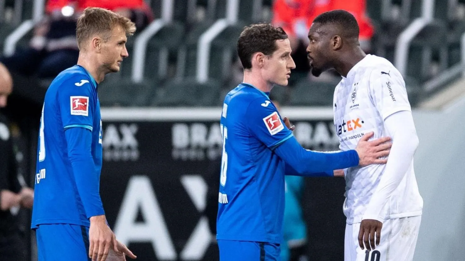 Hoffenheim's Stefan Posch (L) looks on as Hoffenheim's Sebastian Rudy (C) holds back Moenchengladbach's Marcus Thuram (R) during the Bundesliga match on Saturday. (AFP)