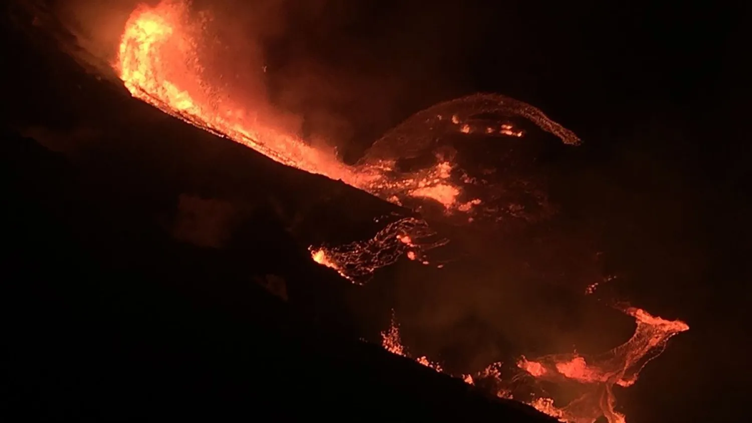 In this photo provided by the US Geological Survey, lava flows within the Halema'uma'u crater of the Kilauea volcano Sunday, Dec. 20, 2020. The Kilauea volcano on Hawaii's Big Island has erupted, the US Geological Survey said. (US Geological Survey via AP)