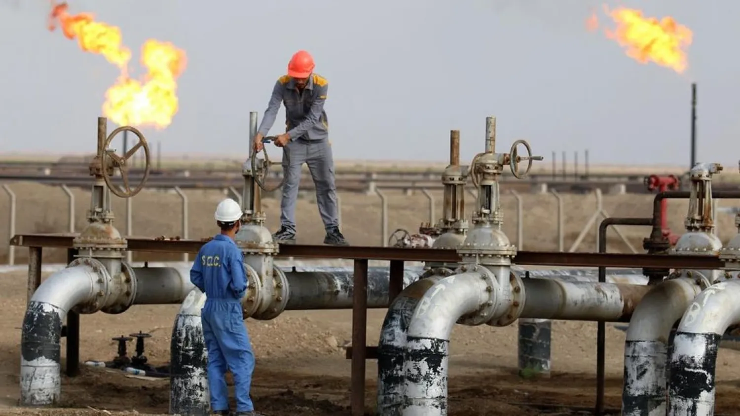 File photo of workers at an oil refinery in the southern town Nasiriyah. (AFP)
