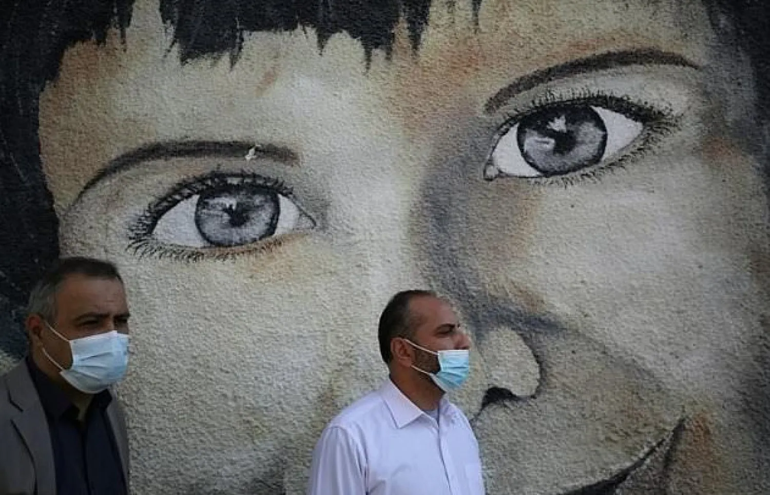 Employees protest outside the headquarters of UNRWA, which is set to receive financial aid from Canada - AFP