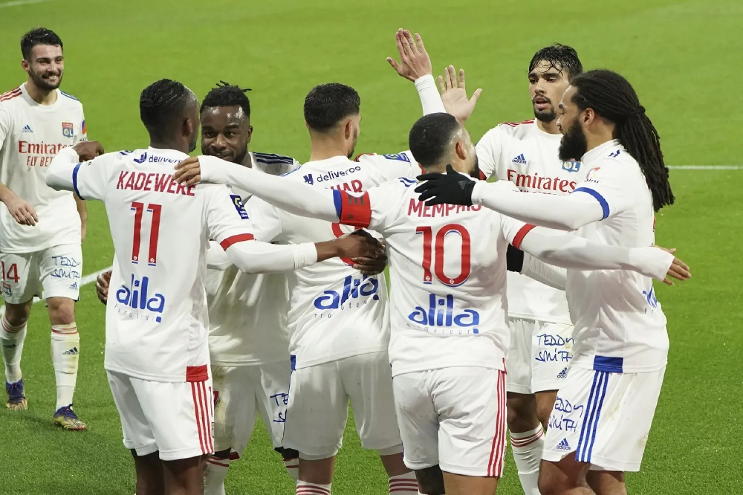 Lyon's Tino Kadewere, left, celebrates with teammates after scoring his side’s second goal during the League One match between Lyon and Nantes, in Decines, central France, Dec. 23, 2020. (AP)