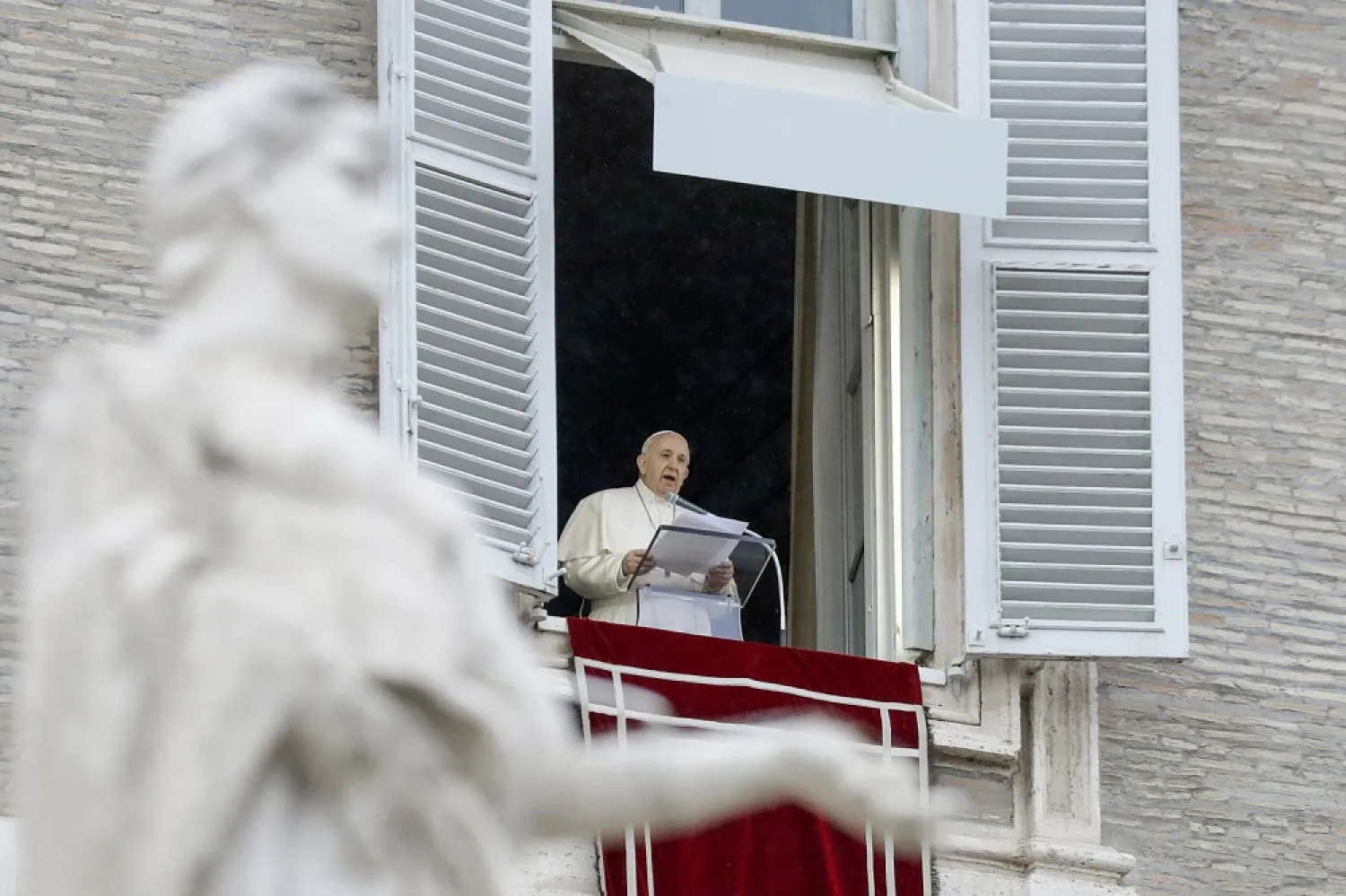 Pope Francis delivers his blessing as he recites the Angelus noon prayer from the window of his studio overlooking St. Peter's Square, at the Vatican, Sunday, Dec. 6, 2020. (AP)