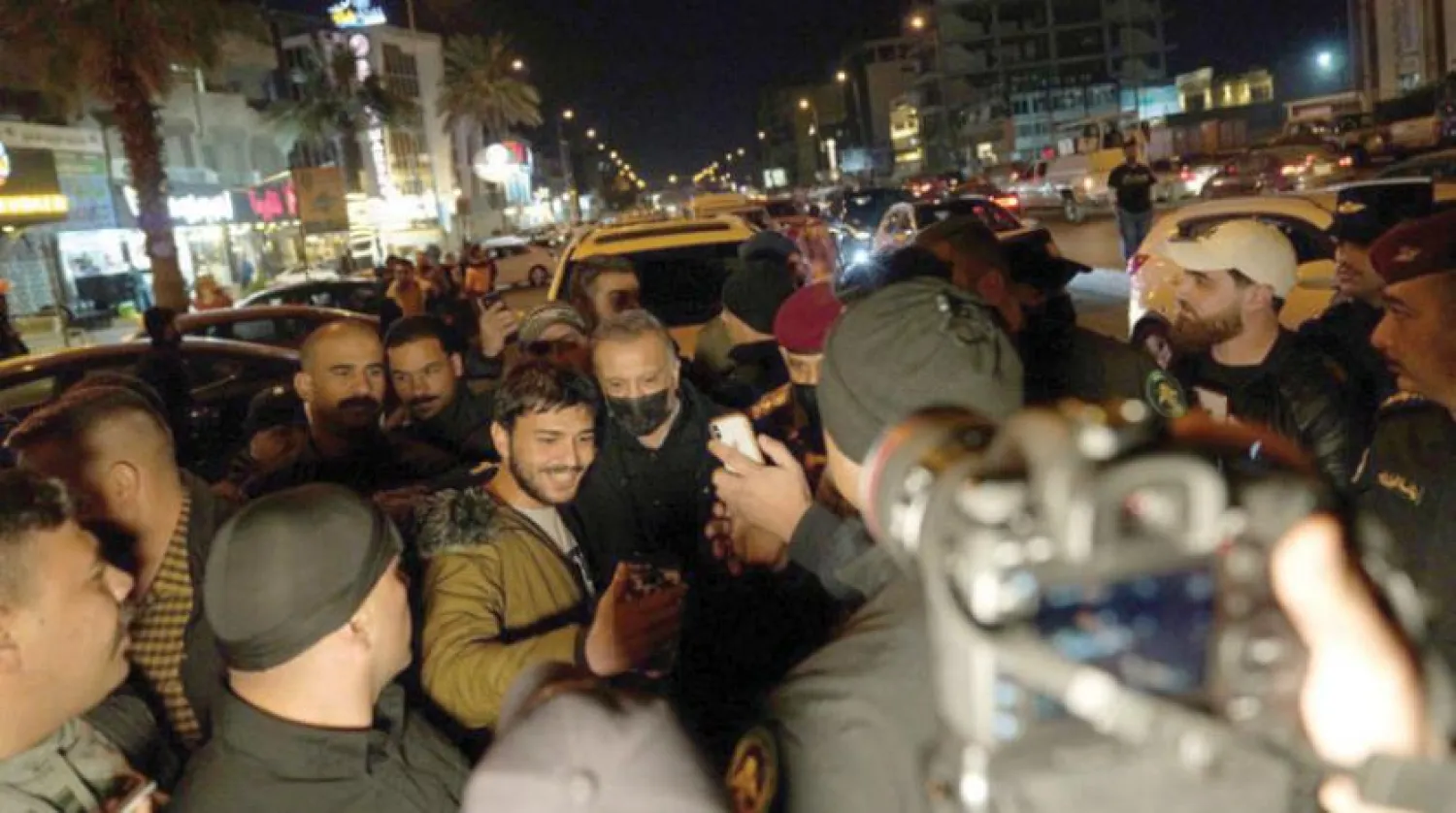Iraqi Prime Minister Mustafa al-Kadhimi takes photos with citizens as he tours Baghdad. (Iraqi Prime Minister's Office)