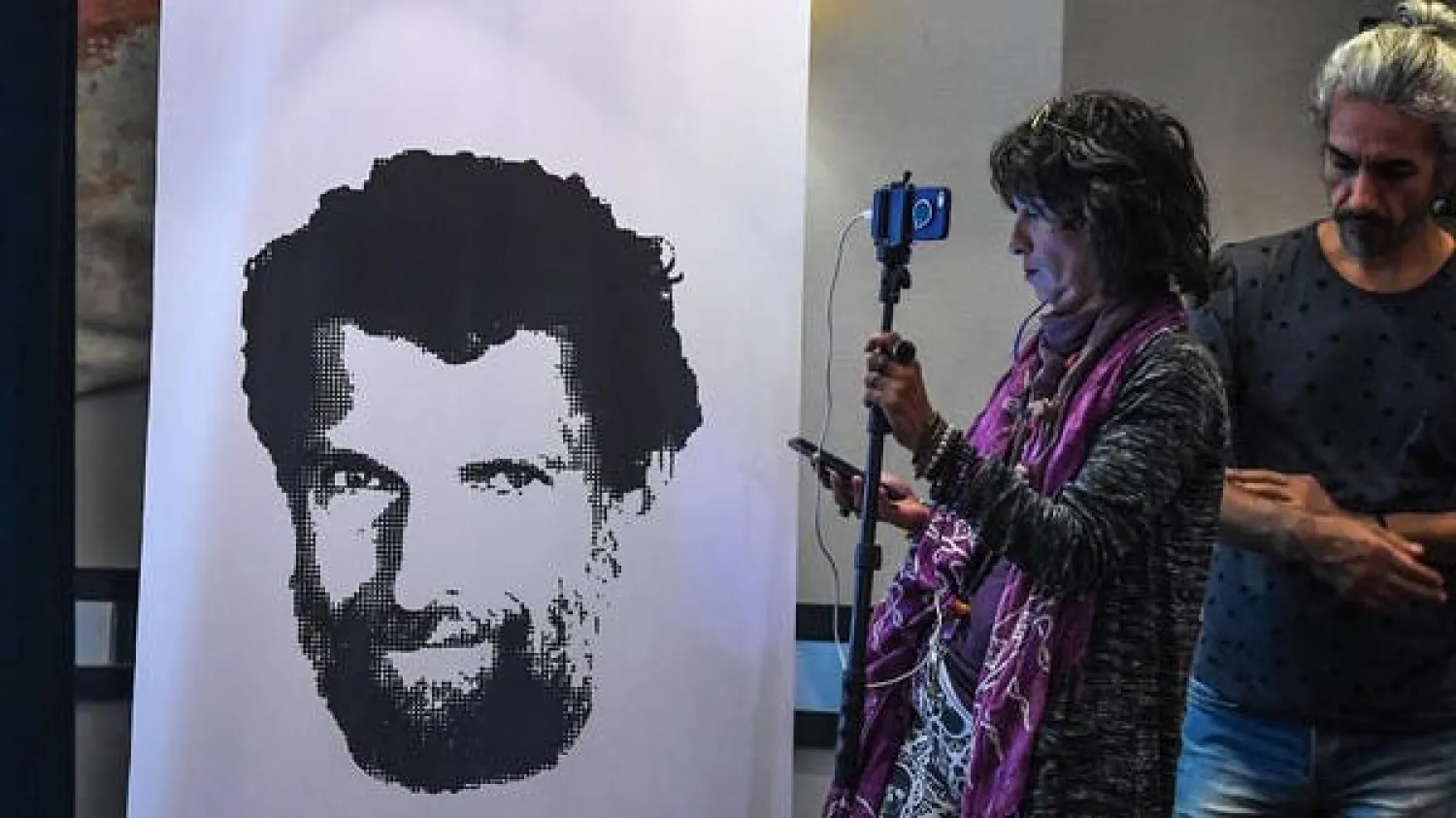A journalist stands in front of a poster featuring jailed businessman and philanthropist Osman Kavala during a press conference of his lawyers on October 31, 2018. (AFP)
