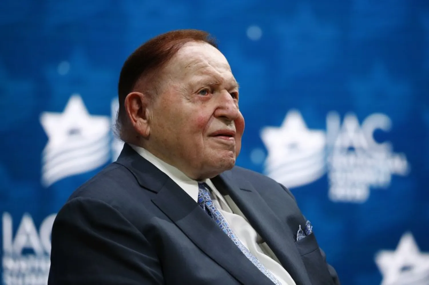 In this Dec. 7, 2019, file photo, Las Vegas Sands Corporation Chief Executive Sheldon Adelson sits onstage before President Donald Trump speaks at the Israeli American Council National Summit in Hollywood, Fla - (AP Photo/Patrick Semansky, File)
