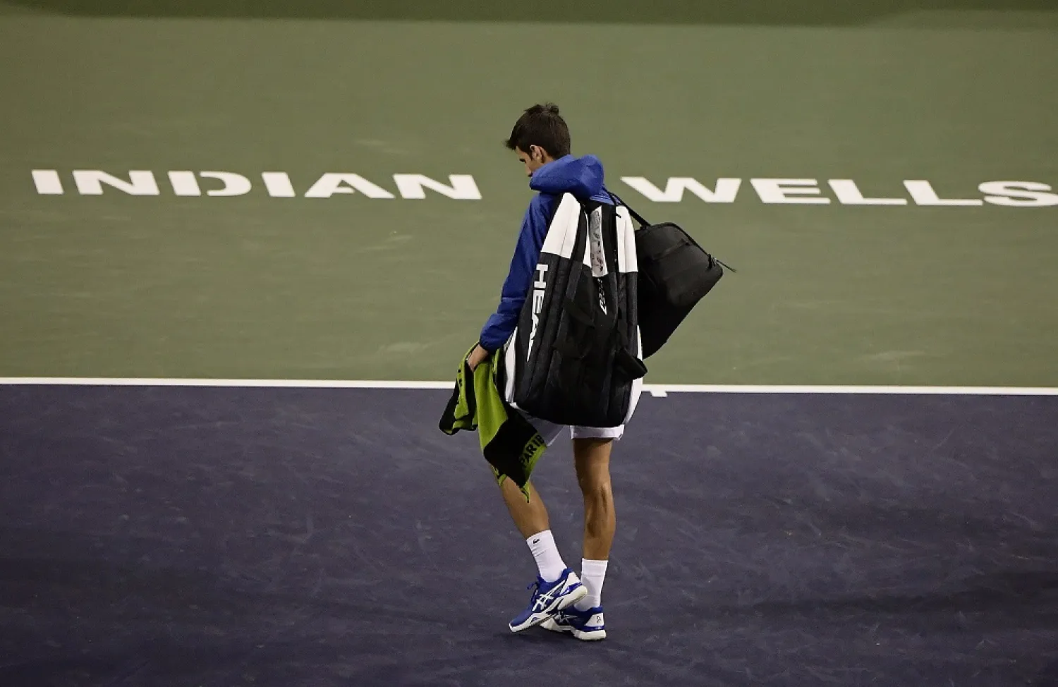 Novak Djokovic walks off the court during a rain break in his match against Philipp Kohlschreiber at the BNP Paribas Open tennis tournament in Indian Wells, California, March 11, 2019. (AP)