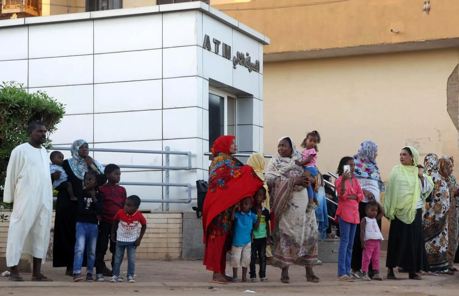 Residents stand outside an automated teller machine (ATM) in Khartoum, Sudan (File photo: Reuters)
